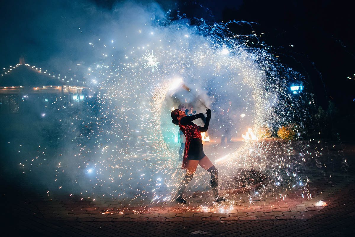 Fire show, fiery sparkling torches.